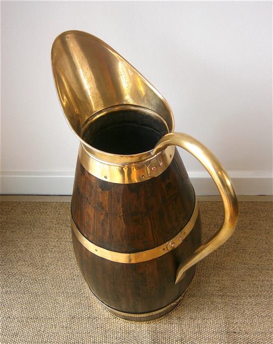 An oak and brass jug stick stand height 66cm